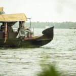 Kerala A close-up view of a traditional houseboat floating on a serene waterway, ideal for travel themes.