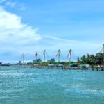 Kerala Traditional Chinese fishing nets line the waterfront in Cochin, India on a bright summer day.